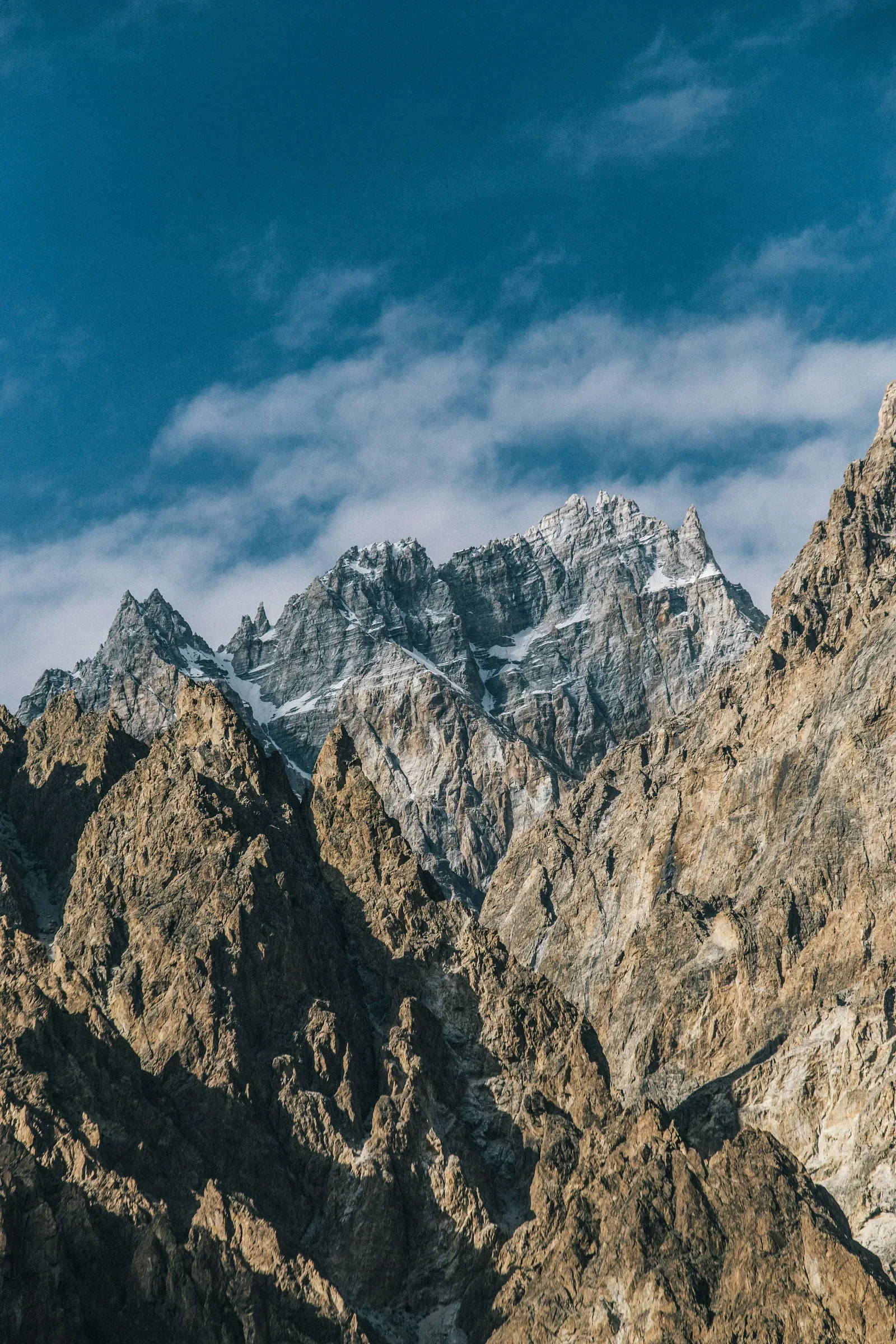 The jagged Passu Cones beneath blue sky in Upper Hunza.