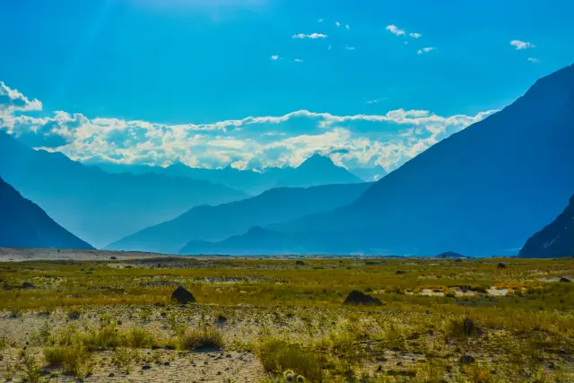 Cold-desert landscape with distant mountains near Skardu.